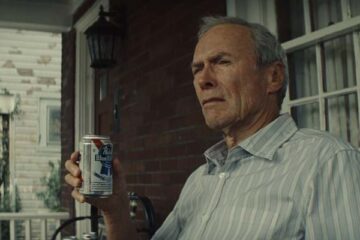 Gran Torino 2008 Movie Scene Clint Eastwood as Walt Kowalski drinking beer and smoking on his porch