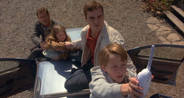 Signs 2002 Movie Scene Hess family using a baby monitor to listen for the aliens