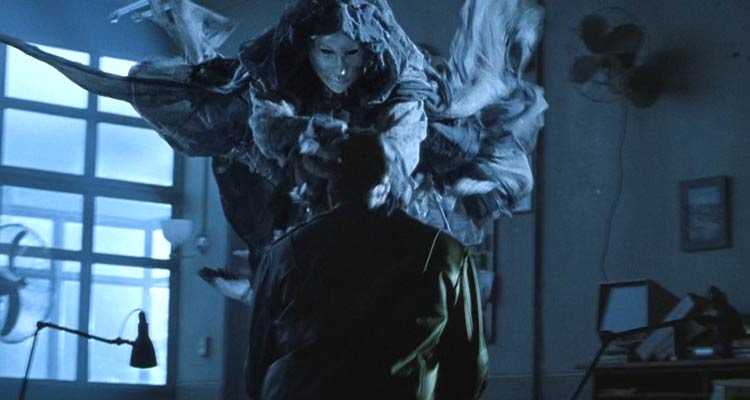 Darkness Falls 2003 Movie Scene The tooth fairy with a porcelain mask and a black cape killing one of the cops in a police station