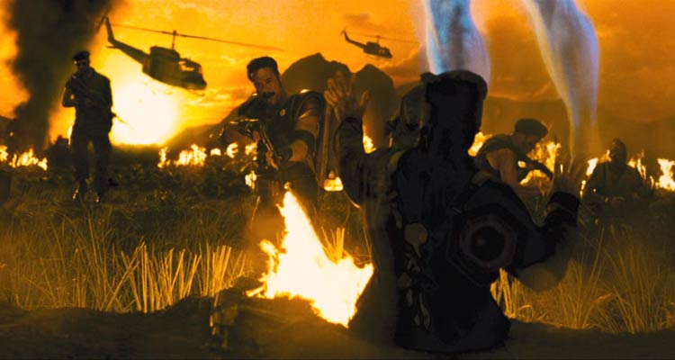 Watchmen 2009 Movie Scene Jeffrey Dean Morgan as Edward Blake AKA Comedian using a flamethrower to burn people during the Vietnam war with helicopters in the background