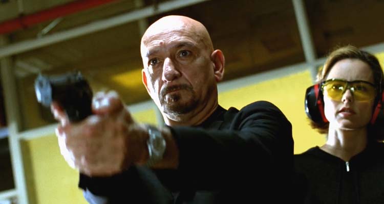 You Kill Me 2007 Movie Scene Ben Kingsley as Frank Falenczyk holding a gun in a gun range with Téa Leoni as Laurel standing behind him