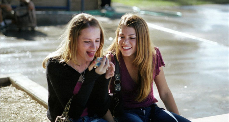 Thirteen 2003 Movie Nikki Reed as Evie Zamora and Evan Rachel Wood as Tracy Freeland looking at new tongue piercing in a mirror and laughing