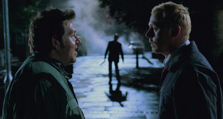 Shaun of the Dead 2004 Movie Scene Simon Pegg as Shaun and Nick Frost as Edgar returning drunk home from pub and not noticing zombies around them