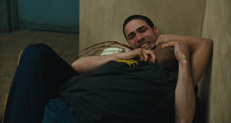 A Prophet 2009 Movie Scene Tahar Rahim as Malik El Djebena using a razor blade to cut another inmates carotid artery