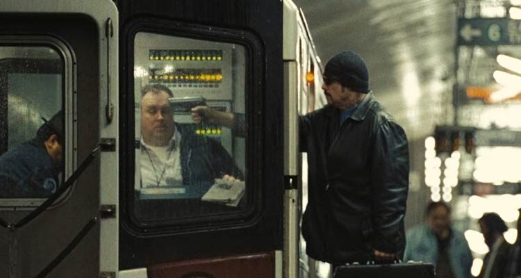 The Taking of Pelham 123 2009 Movie Scene John Travolta as Ryder holding a gun to subway train conductor's head and taking him hostage
