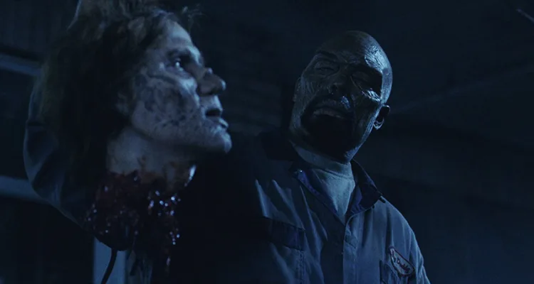 Land of the Dead 2005 Movie Scene Eugene Clark as Big Daddy, zombie leader holding the head of one of his zombie friends