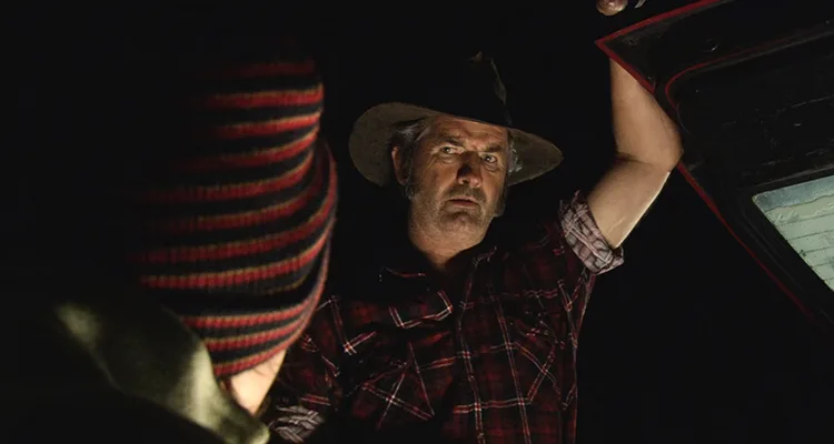 Wolf Creek 2005 Movie Scene John Jarratt as Mick Taylor opening the hood of the car in the night