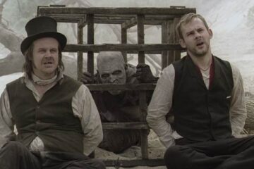 I Sell The Dead 2008 Movie Scene Dominic Monaghan as Arthur Blake and Larry Fessenden as Willy Grimes tied next to a cage with zombie in it