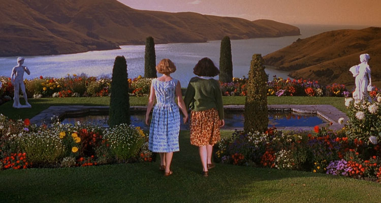 Heavenly Creatures 1994 Movie Scene Melanie Lynskey as Pauline Parker and Kate Winslet as Juliet Hulme holding hands in their imaginary garden
