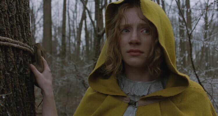 The Village 2004 Movie Scene Bryce Dallas Howard as Ivy Walker wearing a yellow cloak and standing on the edge of the woods