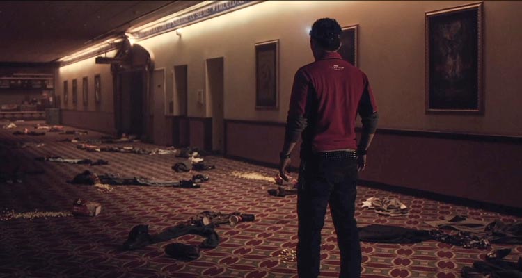 Vanishing On 7th Street 2010 Movie Scene John Leguizamo as Paul in the movie theater looking at the cloths of people who simply disappeared