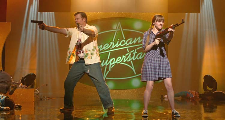 God Bless America 2011 Movie Scene Joel Murray as Frank firing two guns and Tara Lynne Barr as Roxy shooting from an AK-47 on the set of American Superstar