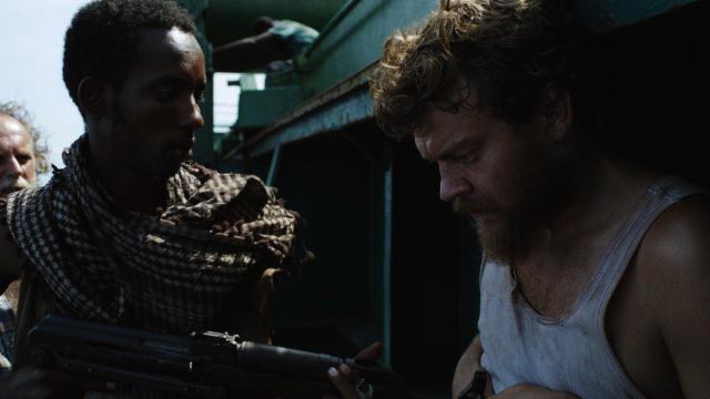 A Hijacking AKA Kapringen [2012] Movie Pilou Asbæk being taken outside the ship by the somali pirates scene