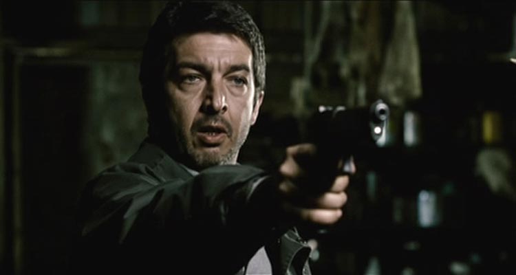 El Aura AKA The Aura 2005 Movie Scene Ricardo Darín as Taxidermista, Esteban Espinosa holding a gun in the forest after a heist