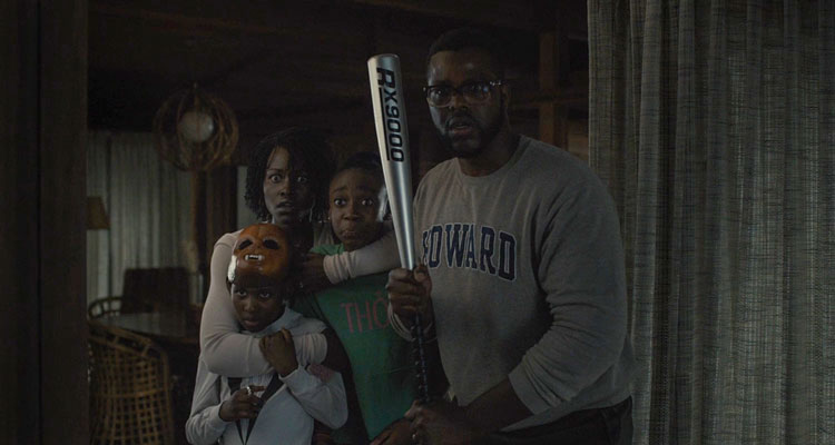 Us 2019 Movie Scene Winston Duke holding a baseball bat with the rest of the family behind him as they first see the strangers