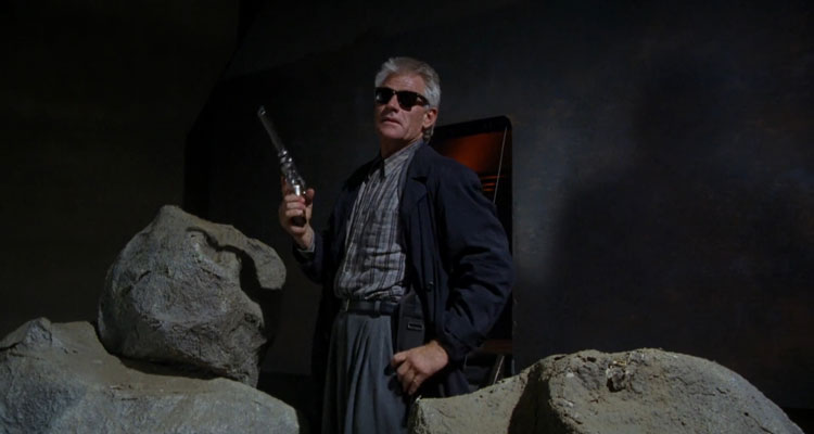 Dollman 1991 Movie Scene Tim Thomerson as Brick Bardo in front of his spaceship holding a huge gun