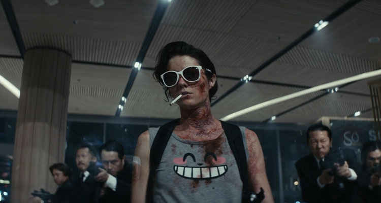 Kate 2021 Movie Scene Mary Elizabeth Winstead as Kate wearing sunglasses and smoking a cigarette