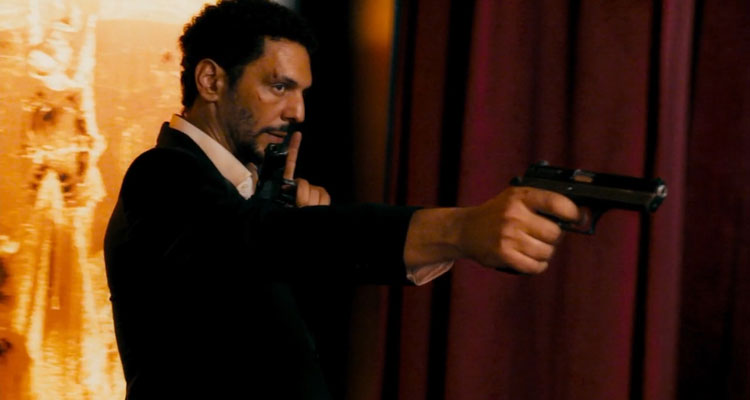 Sleepless Night AKA Nuit Blanche Movie 2011 Scene Tomer Sisley as Vincent holding a gun in a nightclub