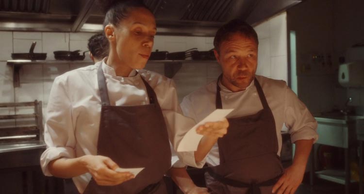 Boiling Point 2021 Movie Scene Vinette Robinson as Carly and Stephen Graham as Andy Jones reading orders to the chefs in a restaurant