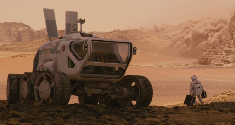 The Last Days On Mars 2013 Movie Scene An astronaut standing next to a huge Mars rover with the storm approaching on the horizon