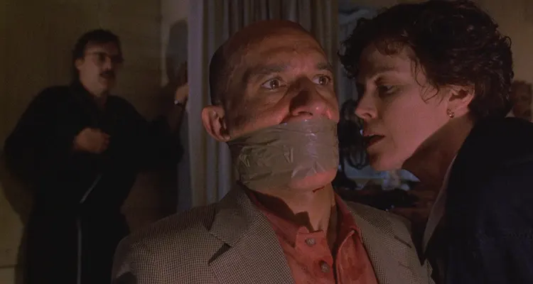 Death and the Maiden 1994 Movie Scene Sigourney Weaver as Paulina talking to Ben Kingsley as Dr. Roberto Miranda who's gagged and bound to a chair