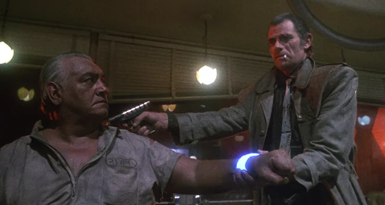Trancers 1984 Movie Scene Tim Thomerson as Jack Deth holding a laser pistol to a suspected trancer
