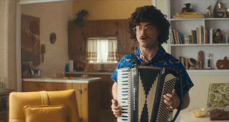 Weird The Al Yankovic Story 2022 Movie Scene Daniel Radcliffe as Weird Al in a Hawaiian shirt and playing an accordion