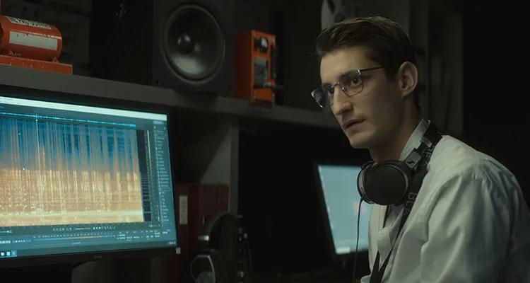 Black Box AKA Boite Noir 2021 Movie Scene Pierre Niney as Mathieu Vasseur listening to the black box recording