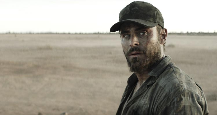 Gold 2022 Movie Scene Zac Efron as Virgil looking at the wild dogs circling him