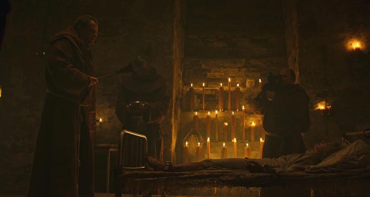 Hellhole 2022 Movie Scene Olaf Lubaszenko as Prior Andrzej performing an exorcism