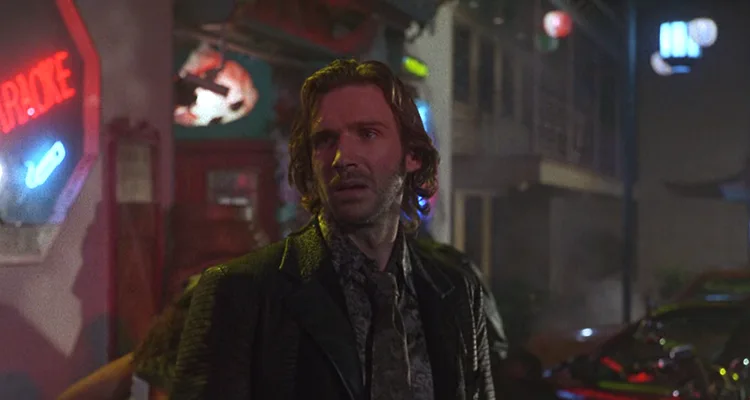 Strange Days 1995 Movie Scene Ralph Fiennes as Lenny Nero outside a seedy bar in back alley with a neon light behind him