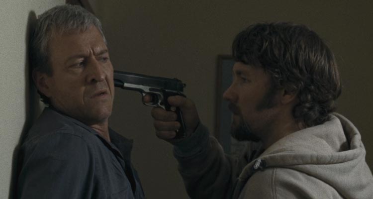 The Square 2008 Movie Scene Joel Edgerton as Billy holding a gun to David Roberts as Raymond's head and demanding the money he owes him