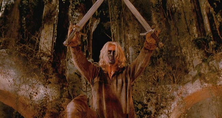 Brotherhood Of The Wolf 2001 Movie Scene Samuel Le Bihan as Grégoire de Fronsac holding two swords with his face painted