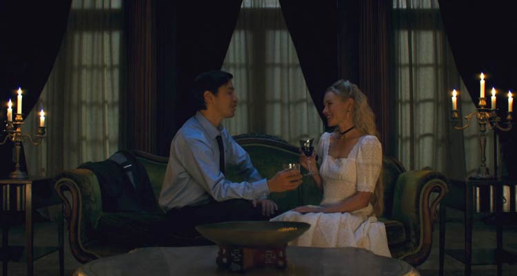House of Darkness 2022 Movie Scene Kate Bosworth as Mina and Justin Long as Hap talking and drinking in her mansion