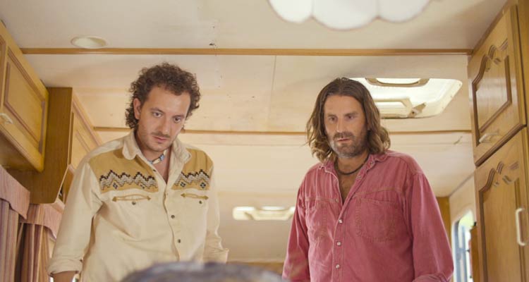 Mandibles 2020 Movie Scene Grégoire Ludig as Manu and David Marsais as Jean-Gab looking at the giant fly they just found