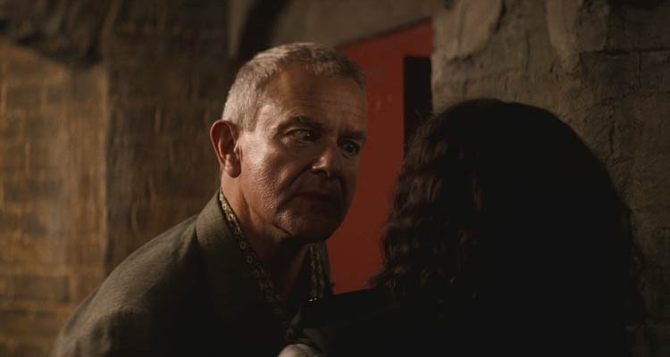 I Came By 2022 Movie Scene Hugh Bonneville as Hector Blake taunting Franc Ashman as DS Ella Lloyd during the search of his house