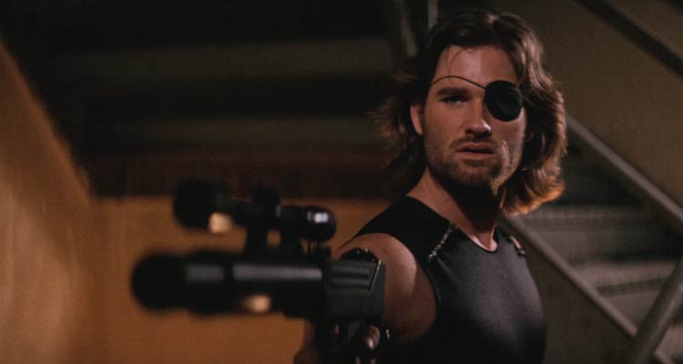 Escape From New York 1981 Movie Scene Kurt Russell as Snake Plissken wearing an eye patch and holding an Uzi with a silencer and a scope