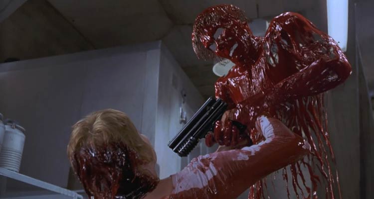 Hollow Man 2000 Movie Scene Kevin Bacon as Sebastian Caine invisible but covered in blood and holding a tranquilizer gun