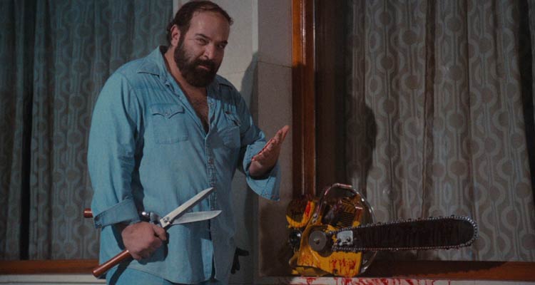 Pieces 1982 Movie Scene Paul L. Smith as Willard the gardener standing next to the bloody chainsaw and holding a huge set of sheers