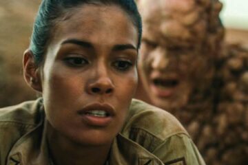 The Hills Have Eyes 2 2007 Movie Scene Daniella Alonso as Missy standing unaware that a huge mutant is about to attack her from behind