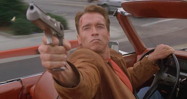 Last Action Hero 1993 Movie Scene Arnold Schwarzenegger as Jack Slater driving a car and shooting his desert eagle gun at the bad guys