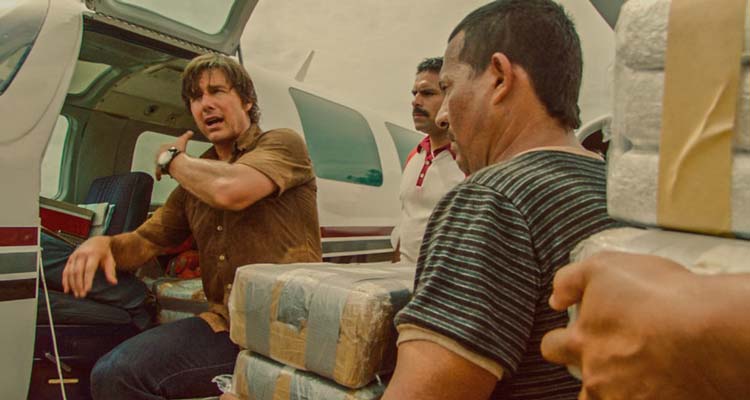 American Made 2017 Movie Scene Tom Cruise as Barry Seal instructing people to load cocaine onto his airplane