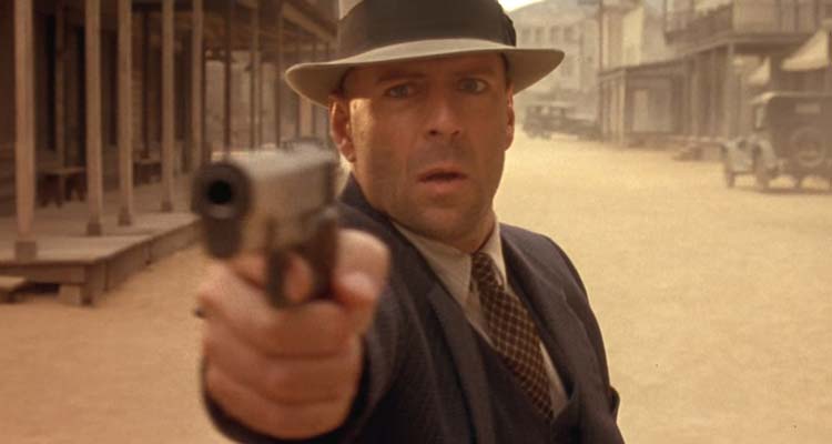 Last Man Standing 1996 Movie Scene Bruce Willis as John Smith holding his Colt 1911 handgun in the street of a small town of Jericho