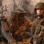 Starship Troopers 1997 Movie Scene Casper Van Dien as Johnny Rico in front of a bug he just blew up