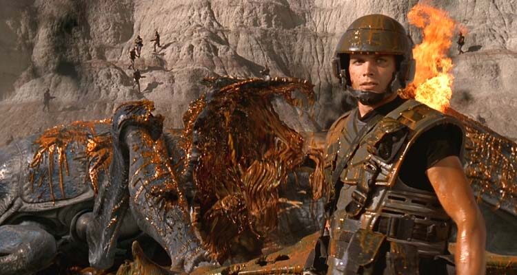 Starship Troopers 1997 Movie Scene Casper Van Dien as Johnny Rico in front of a bug he just blew up