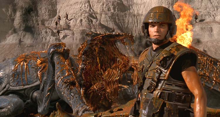 Starship Troopers 1997 Movie Scene Casper Van Dien as Johnny Rico in front of a bug he just blew up