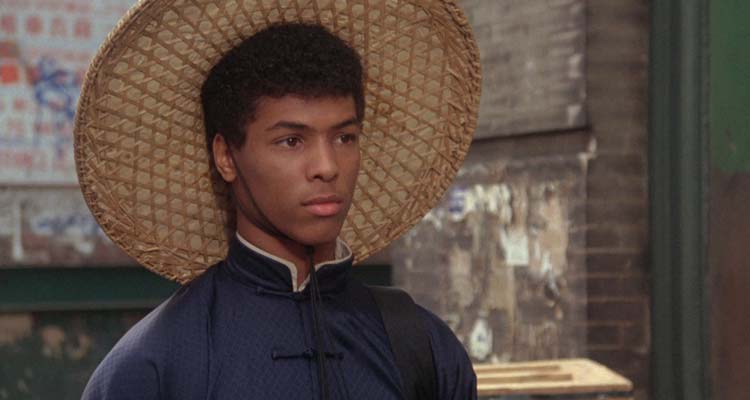 The Last Dragon 1985 Movie Scene Taimak as Bruce Leroy wearing a straw hat and a kimono