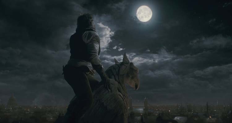 The Wolfman 2010 Movie Scene With a werewolf howling at the moon on top of a building holding on to a marble gargoyle sculpture
