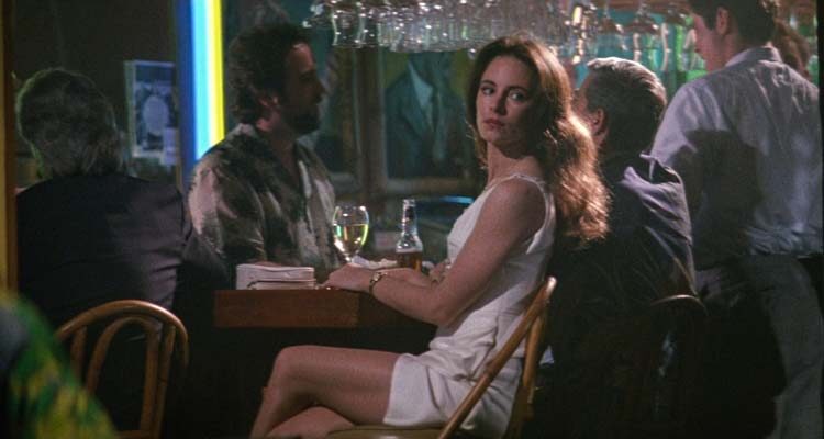 China Moon 1994 Movie Scene Madeleine Stowe as Rachel Munro in a white dress at a bar looking like a real femme fatale