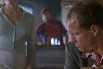 Palmetto 1998 Movie Scene Woody Harrelson as Harry Barber in the bar watching femme fatale walk by him